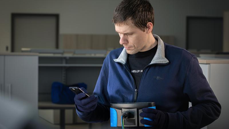 MI 3107 EurotestEASI Touch, electrician performing loop impedance and insulation resistance measurement on electrical installation